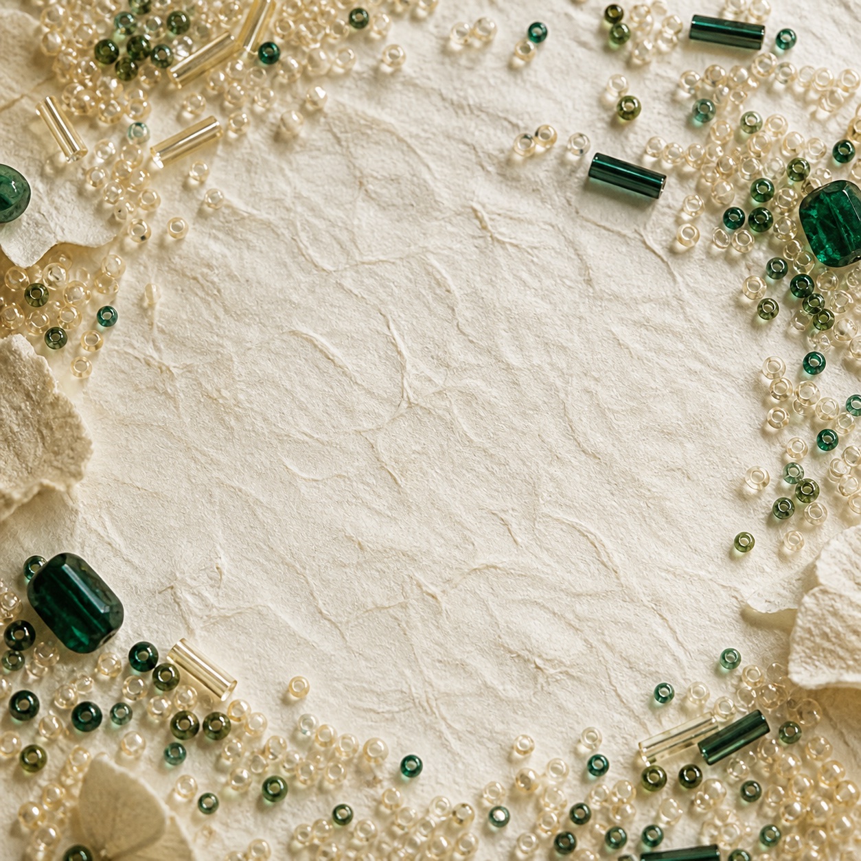 Loose glass beads arranged on ivory paper